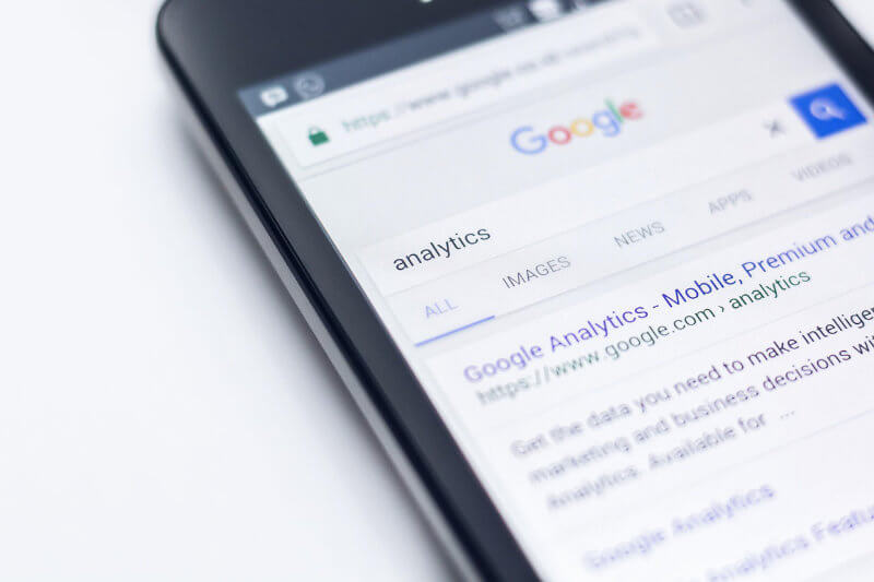A Google ads specialists marketing services agency's phone with Google analytics on the screen